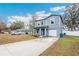 Two-story house with gray siding, a driveway, and a small front yard at 27096 Wakefield Dr, Brooksville, FL 34602