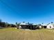 Aerial view of a house with solar panels and a large yard at 7301 Anacapa Ln, Plant City, FL 33565