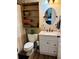 Clean bathroom with a white vanity and wood shelving at 7301 Anacapa Ln, Plant City, FL 33565