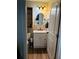 Bathroom with white vanity, granite countertop, and wood shelving at 7301 Anacapa Ln, Plant City, FL 33565