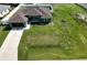 Single-story home with a brown roof and large grassy yard at 4154 Duluth Ter, North Port, FL 34286