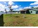 Spacious backyard with a white vinyl fence and mature trees at 4154 Duluth Ter, North Port, FL 34286