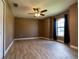 Bright bedroom with wood-look tile floors and a large window at 4154 Duluth Ter, North Port, FL 34286