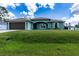 Single-story home with a brown garage door and green exterior at 4154 Duluth Ter, North Port, FL 34286