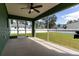 Spacious screened porch with ceiling fan and backyard access at 4154 Duluth Ter, North Port, FL 34286