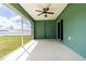 Screened porch with ceiling fan and sliding glass door at 4154 Duluth Ter, North Port, FL 34286