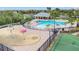 Aerial view of a community swimming pool, splashpad, and basketball court with a cabana at 4507 Savannah Holly Pl, Riverview, FL 33578