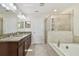 Elegant bathroom with granite countertop, double sinks, and a soaking tub at 13752 Reindeer Cir, Hudson, FL 34669