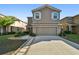 Two-story house with neutral exterior, attached garage, and landscaping at 13752 Reindeer Cir, Hudson, FL 34669