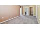 Light-filled hallway with carpeted floors and access to bedrooms and bathroom at 13752 Reindeer Cir, Hudson, FL 34669