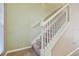 Carpeted staircase with white railing and neutral wall colors at 13752 Reindeer Cir, Hudson, FL 34669