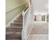 Carpeted staircase with white railing leading to the second floor at 13752 Reindeer Cir, Hudson, FL 34669