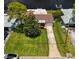 Aerial view of a single-story home with a driveway and green lawn near the water at 237 Tallahassee Ne Dr, St Petersburg, FL 33702