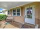 Inviting front porch with a bench and decorative wreath on the front door at 237 Tallahassee Ne Dr, St Petersburg, FL 33702