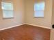 Spacious bedroom with hardwood floors and two windows at 4701 22Nd N Ave, St Petersburg, FL 33713