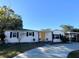 Charming white house with yellow door, landscaping, and a long driveway at 4701 22Nd N Ave, St Petersburg, FL 33713