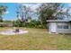 Backyard with firepit, shed, and seating at 4760 84Th N Ter, Pinellas Park, FL 33781