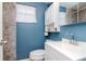 Clean bathroom with white vanity and blue walls at 4760 84Th N Ter, Pinellas Park, FL 33781