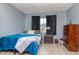 Cozy bedroom with teal blanket, wood floors, and dresser at 4760 84Th N Ter, Pinellas Park, FL 33781