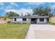 Gray house with white shutters, gravel driveway, and small front yard at 4760 84Th N Ter, Pinellas Park, FL 33781