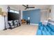 Living room with blue sofa, TV, and blue accent wall at 4760 84Th N Ter, Pinellas Park, FL 33781