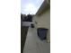 Concrete side yard with trash receptacles and access gate at 11422 Brown Bear Ln, Port Richey, FL 34668