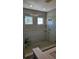 Large walk-in shower with glass enclosure and built-in shelves at 3508 Cowart St, New Port Richey, FL 34655