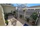 Peaceful brick patio with a screened enclosure, lush potted plants, and bistro seating at 3508 Cowart St, New Port Richey, FL 34655