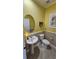 Stylish powder room with pedestal sink and decorative wall art at 3508 Cowart St, New Port Richey, FL 34655