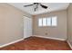 Neutral bedroom with wood-look flooring and louvered doors at 8280 140Th St, Seminole, FL 33776