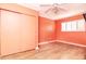 Light coral bedroom with wood-look flooring and double doors at 8280 140Th St, Seminole, FL 33776