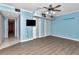 Blue bedroom with wood-look flooring and built-in shelving at 8280 140Th St, Seminole, FL 33776