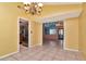Dining room with tile floors, chandelier, and open view to kitchen and Gathering room at 8280 140Th St, Seminole, FL 33776