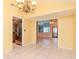 Dining room with tile floors, chandelier, and views of kitchen and Gathering room at 8280 140Th St, Seminole, FL 33776