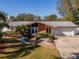 Mid-century modern home with attractive landscaping and a two-car garage at 8280 140Th St, Seminole, FL 33776