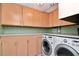 Laundry room with washer, dryer, and ample cabinet space at 8280 140Th St, Seminole, FL 33776