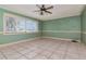Spacious living room with tile floors, ceiling fan, and large window at 8280 140Th St, Seminole, FL 33776