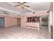 Open living area with high ceilings, tile floors, and a view into the kitchen at 8280 140Th St, Seminole, FL 33776