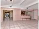 Spacious living room with high ceilings, tile floors, and a kitchen pass-through at 8280 140Th St, Seminole, FL 33776