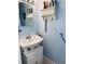 Small bathroom with pedestal sink and grab bar at 1655 58Th S Ter # 3, St Petersburg, FL 33712