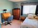 Small bedroom with twin bed and wooden armoire at 1655 58Th S Ter # 3, St Petersburg, FL 33712