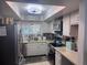 Bright kitchen featuring stainless steel appliances and ample counter space at 1655 58Th S Ter # 3, St Petersburg, FL 33712