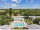 Community pool with surrounding patio and lush landscaping at 1655 58Th S Ter # 3, St Petersburg, FL 33712