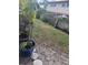 Small side yard with grass and potted plants at 1655 58Th S Ter # 3, St Petersburg, FL 33712