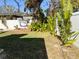 Spacious backyard with grassy area and tropical plants at 2695 68Th S Ave, St Petersburg, FL 33712