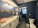 Stylish bathroom with white vanity, vessel sink, and dark blue walls at 2695 68Th S Ave, St Petersburg, FL 33712