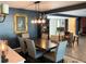 Elegant dining room with dark wood table and chairs, and stylish light fixture at 2695 68Th S Ave, St Petersburg, FL 33712