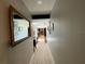 Bright hallway with light wood-look floors and framed artwork at 2695 68Th S Ave, St Petersburg, FL 33712