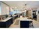 Updated kitchen featuring white and blue cabinets, an island, and stainless steel appliances at 2695 68Th S Ave, St Petersburg, FL 33712