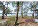 Spacious backyard with mature trees and scenic lake view at 7182 E Bank Dr # 7-103, Tampa, FL 33617